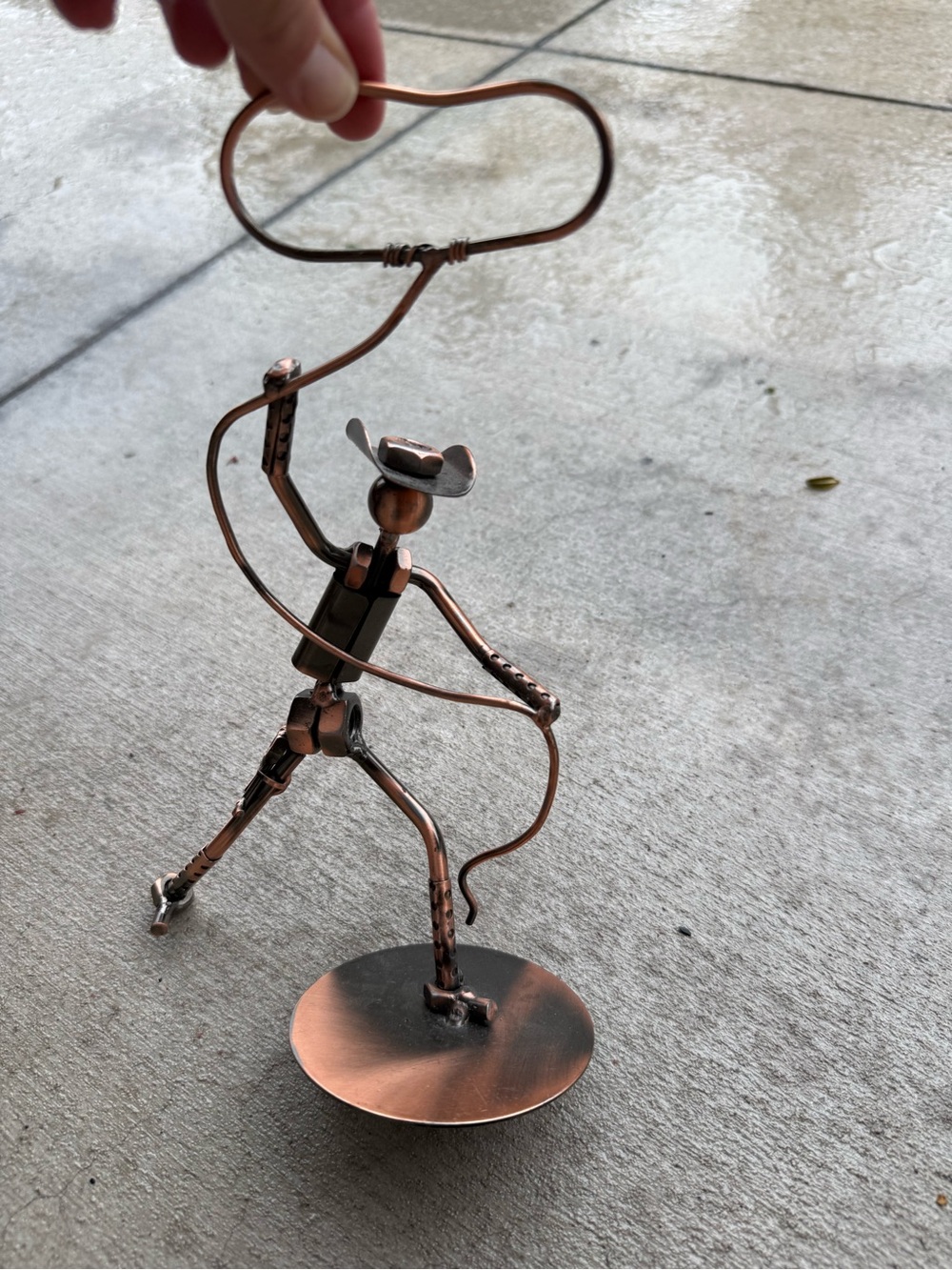 Metal cowboy lassoing decoration 9 3/4” tall copper colored